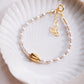 White Freshwater Pearl Bracelet with Gold Pikake Bead - Pōhina